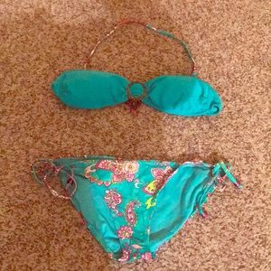Turquoise bathing suit with beaded accent.